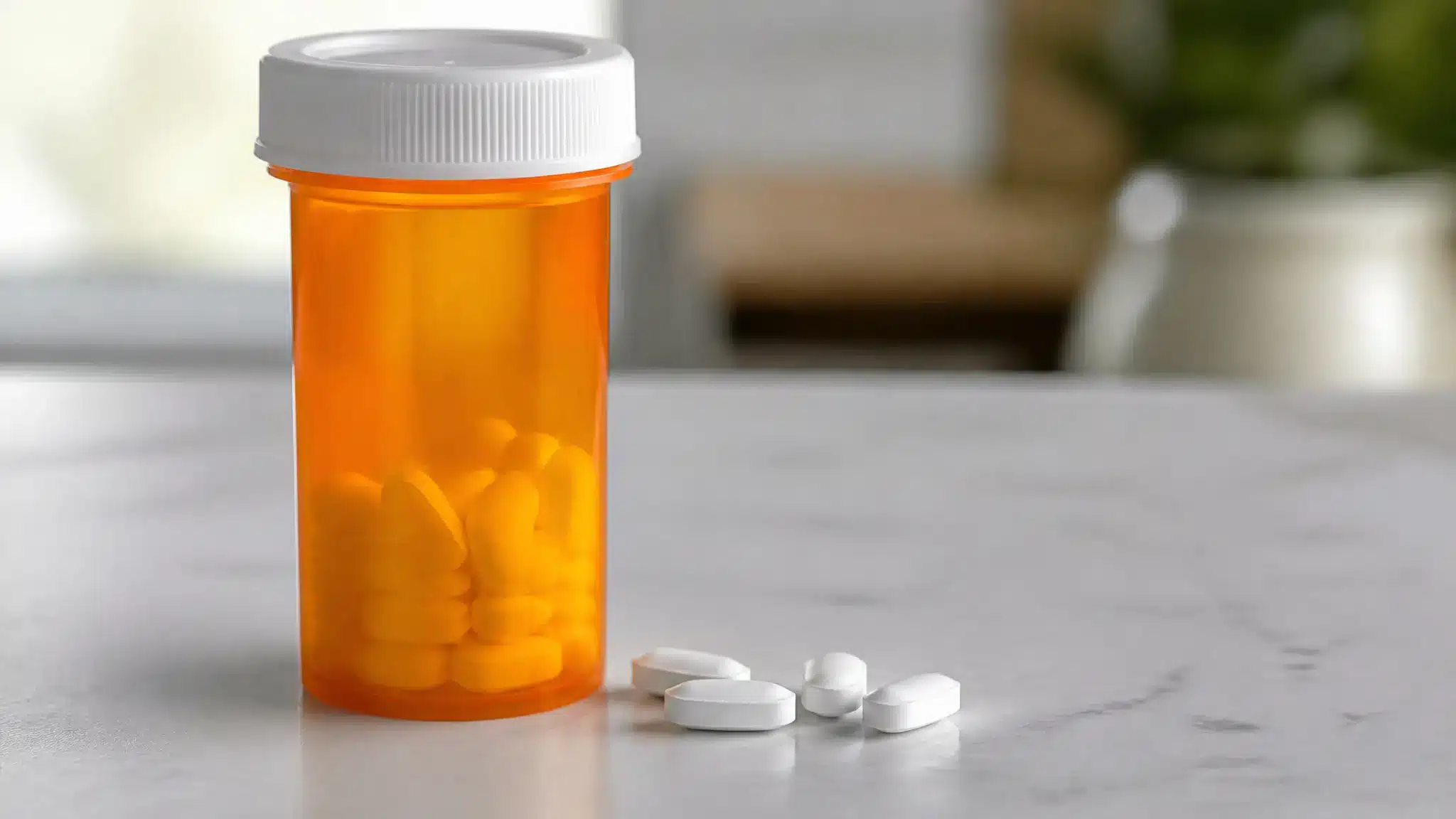 Prescription pill bottle with tablets on a table representing Adderall misuse risks.